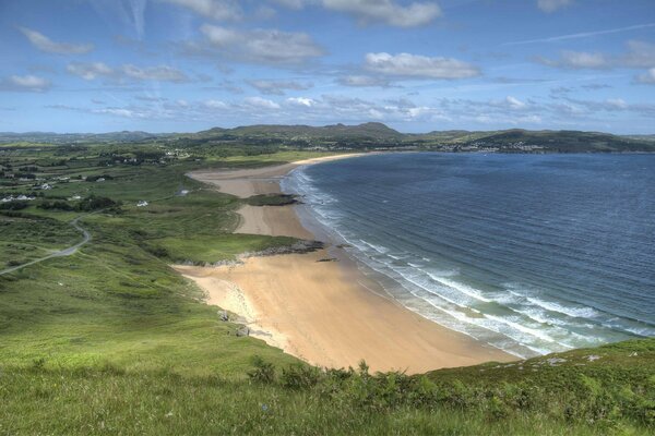 Sea with waves on the shore of a sandy beach