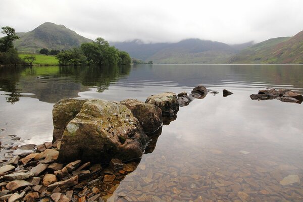 Mountain lake on the background of fog