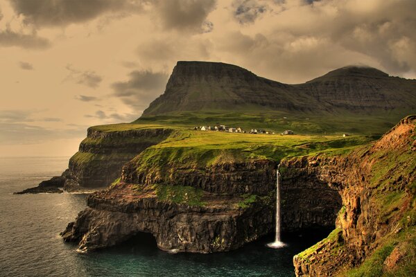 Waterfall among mountains and cliffs