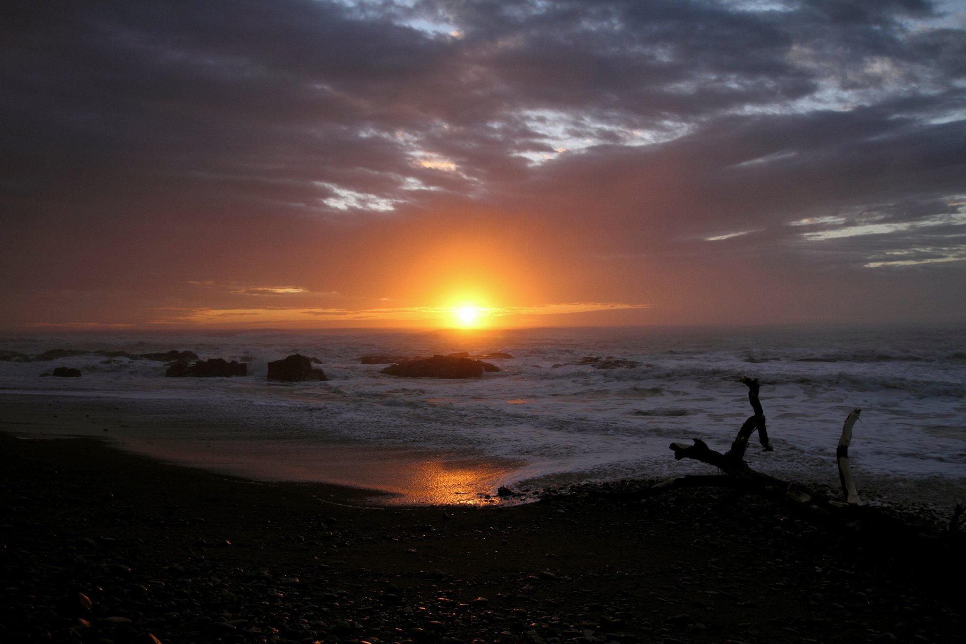 ea beach stones karyaga sun clouds sunset