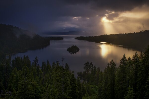 The light of the sun breaking through the clouds in the forest bay