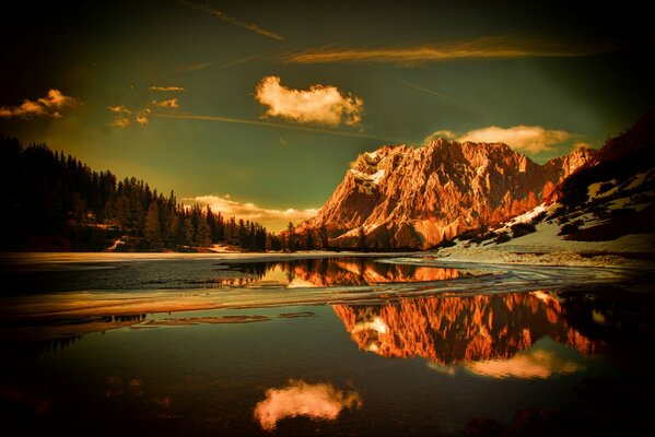 Mountains in the forest among snow and water