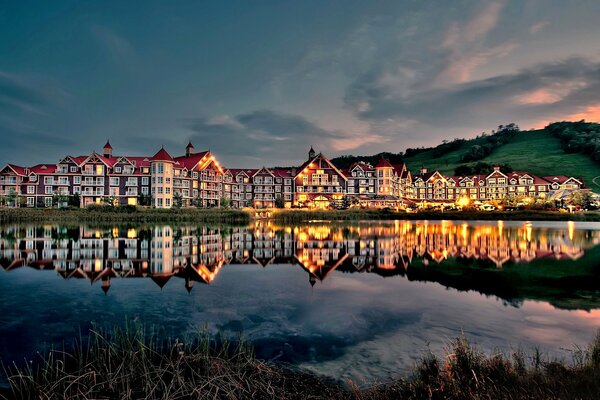 Sunset over the houses on the background of the lake