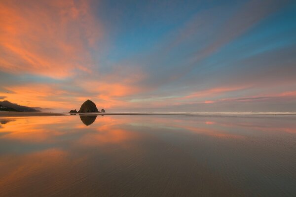 Reflection of clouds in the sea at sunset