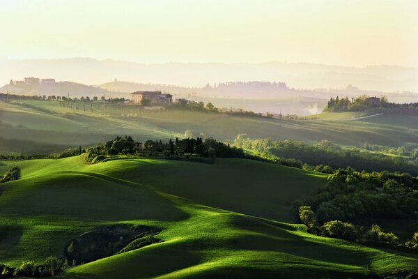 Dawn over green hills and houses