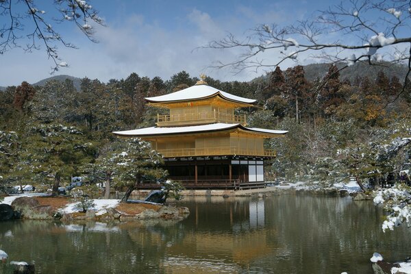 Lonely snow-covered house on the lake shore