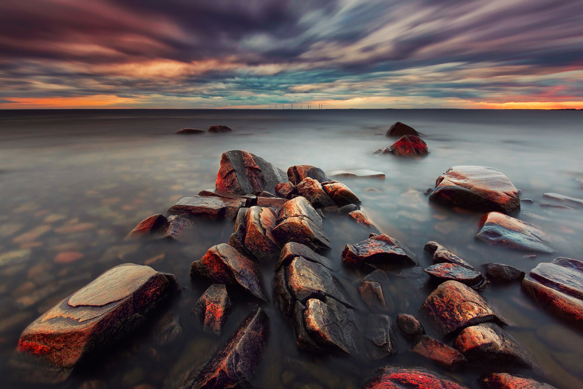 mar suecia tarde nubes puesta de sol piedras