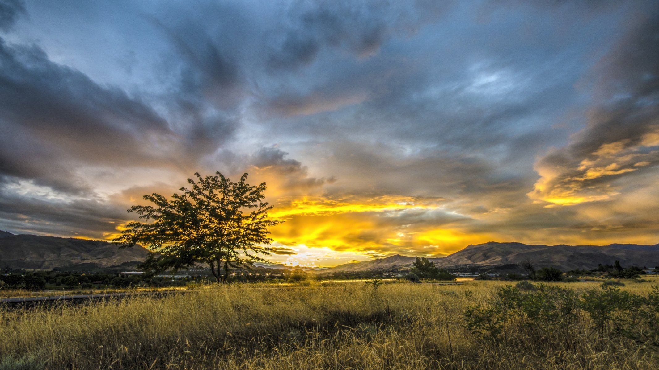 mountain valley tree grass town sun sunset sky cloud