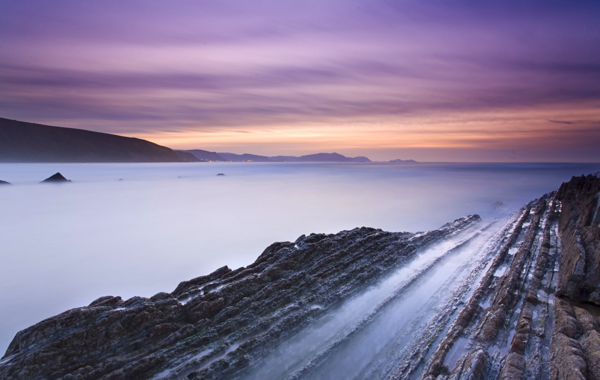 espagne côte falaises baie marée soir coucher de soleil orange ciel lilas