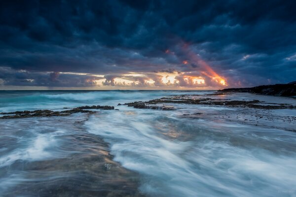 Sunset in the clouds on the background of the ocean