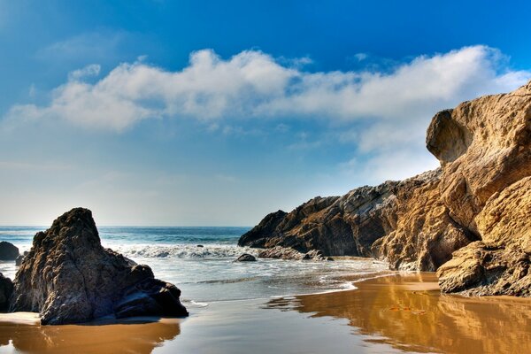 Transparent sea at the earthy rocks