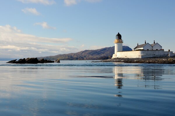 Landscape with reflection of a lighthouse in the sea