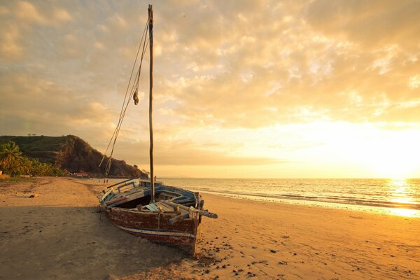 An empty boat on the sea sand