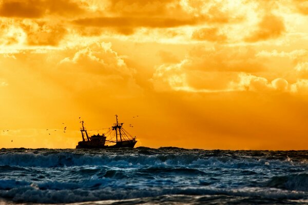 A ship against the background of a fiery sky