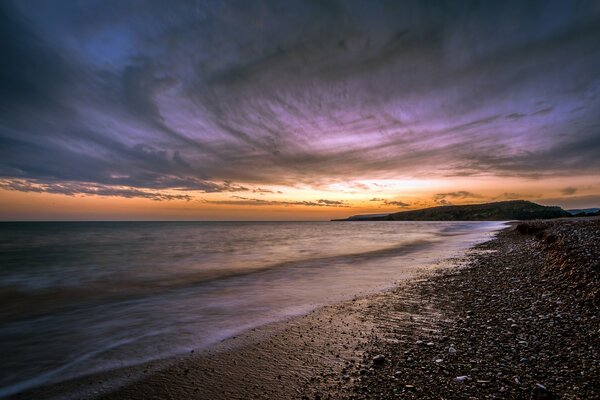 Beautiful sunset on the rocky beach of Cyprus