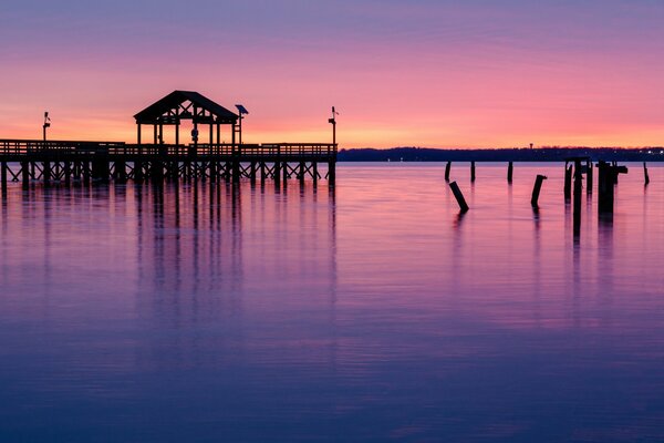 Pier on the background of a lilac sky