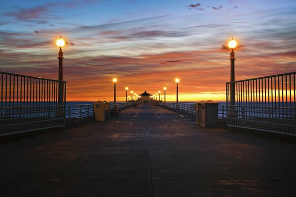 Evening pier illuminated by lanterns in California