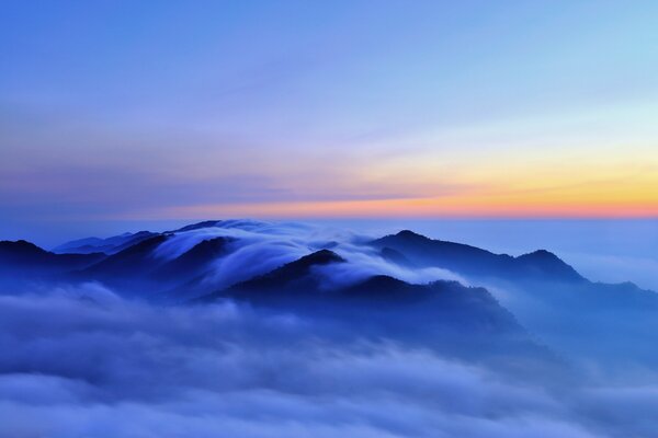 Mountain peaks covered with clouds