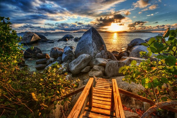 Wooden staircase to the stone sea coast