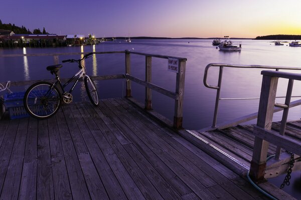 Одинокий велосипед в бухте на закате