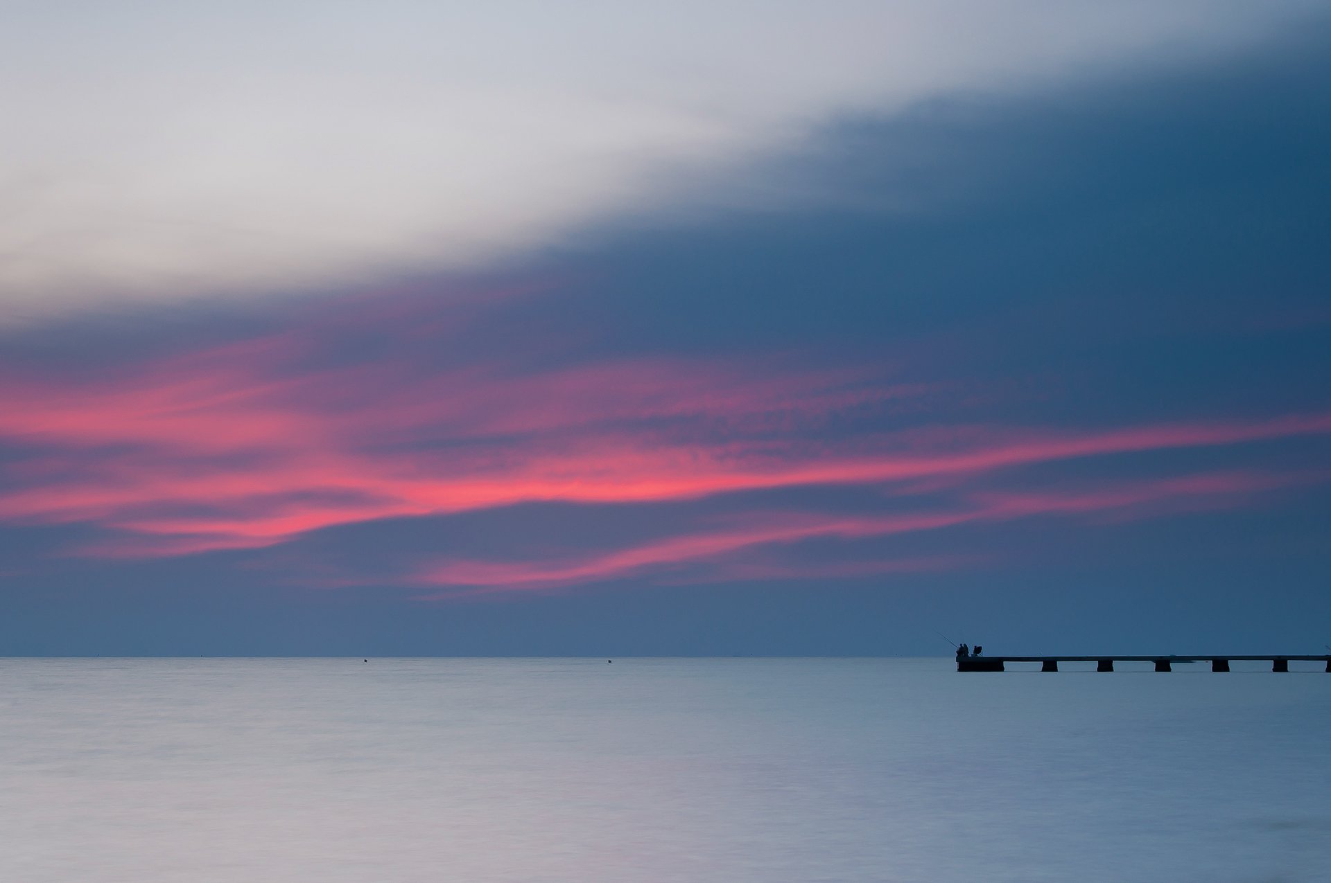 slovenia mare riva in lontananza molo pescatori sera luminoso tramonto blu cielo