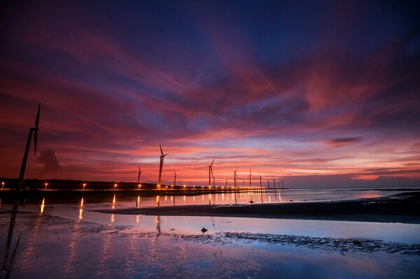 Windmills in the water against the blue sky