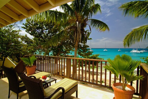 Balcony with two sun loungers overlooking the sea and the beach