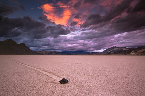 Sunset on a cloudy sky against the background of mountains