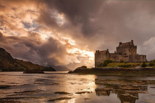 Reflection of the castle in the lake on a cloudy evening