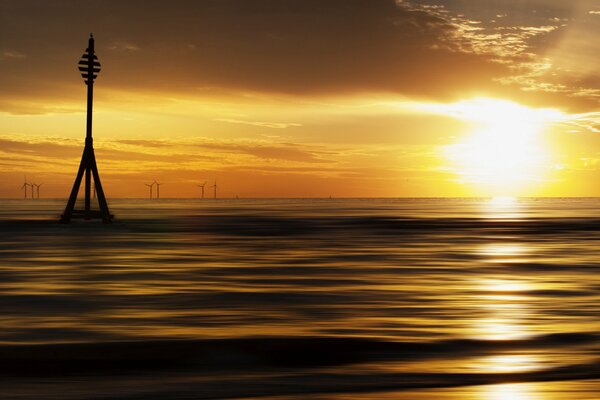 The sea is calm against the background of sunset