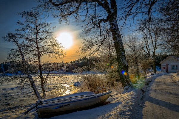 Winter morning . The boat is standing in the snow