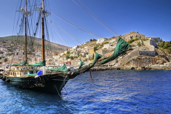 A ship at sea with green sails