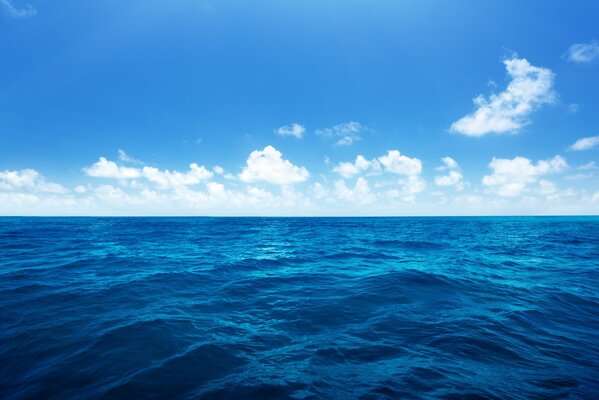 The horizon separating the deep blue sea and the blue sky