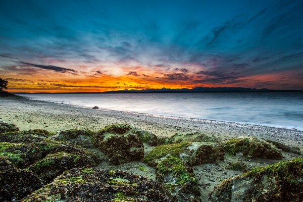 The stone coast of the beach on the bay