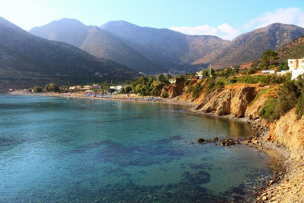 A beach in Greece against the backdrop of mountains