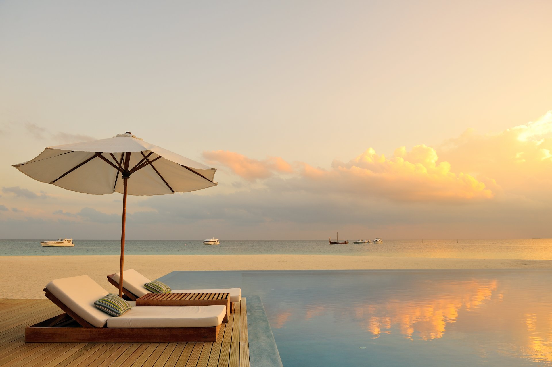 the maldives paradise pool chaise ocean sunset romance