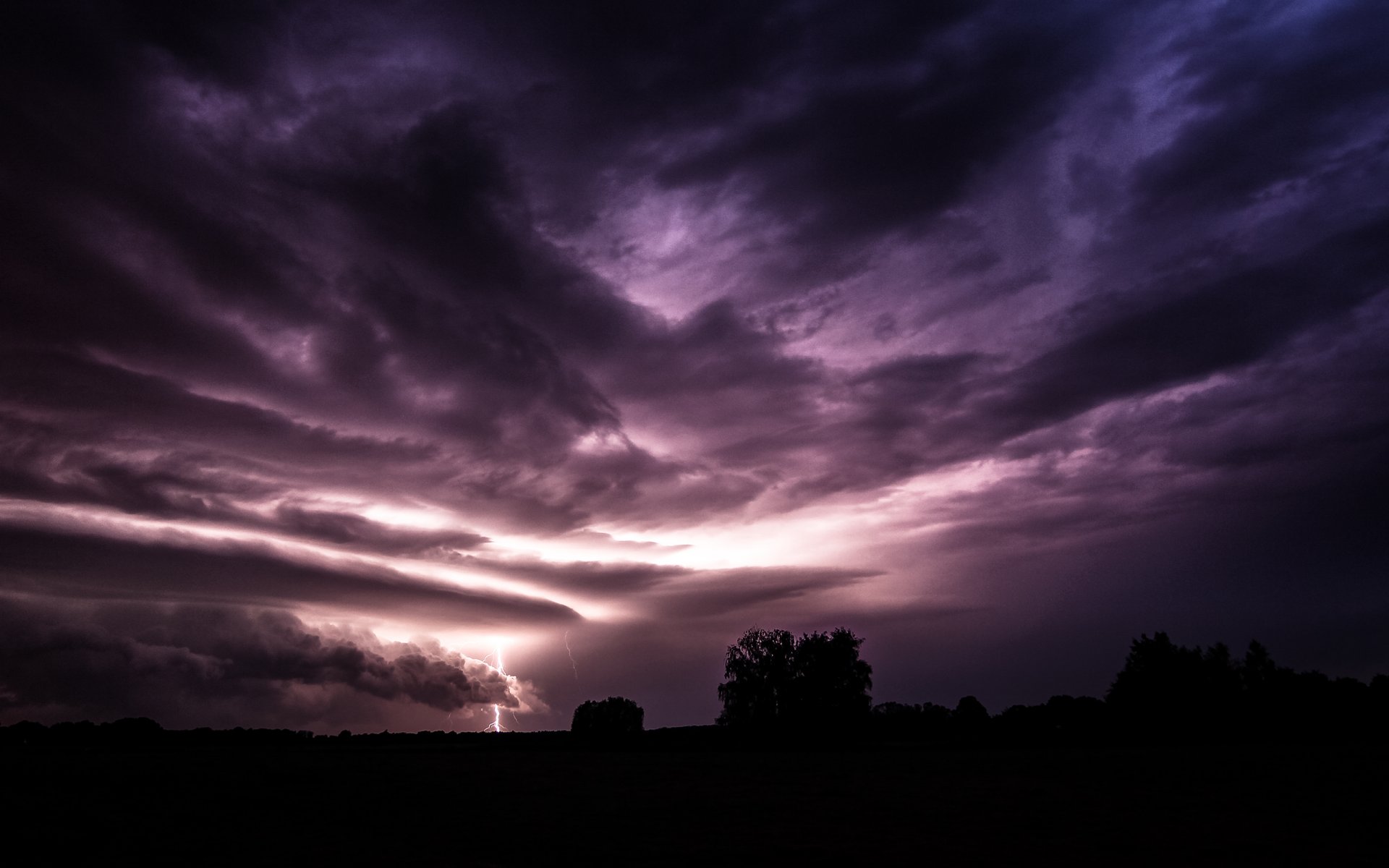 the field night purple sky clouds the storm lightning