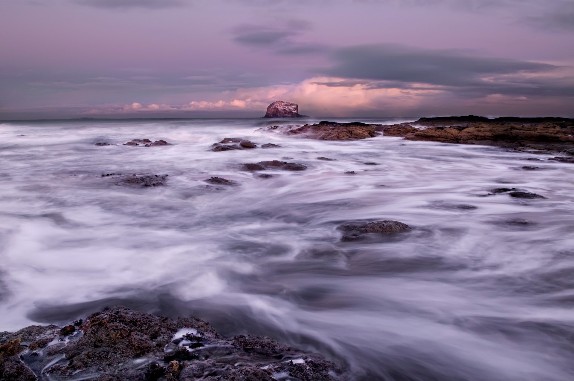 ea ocean waves stones beach grey sky cloud