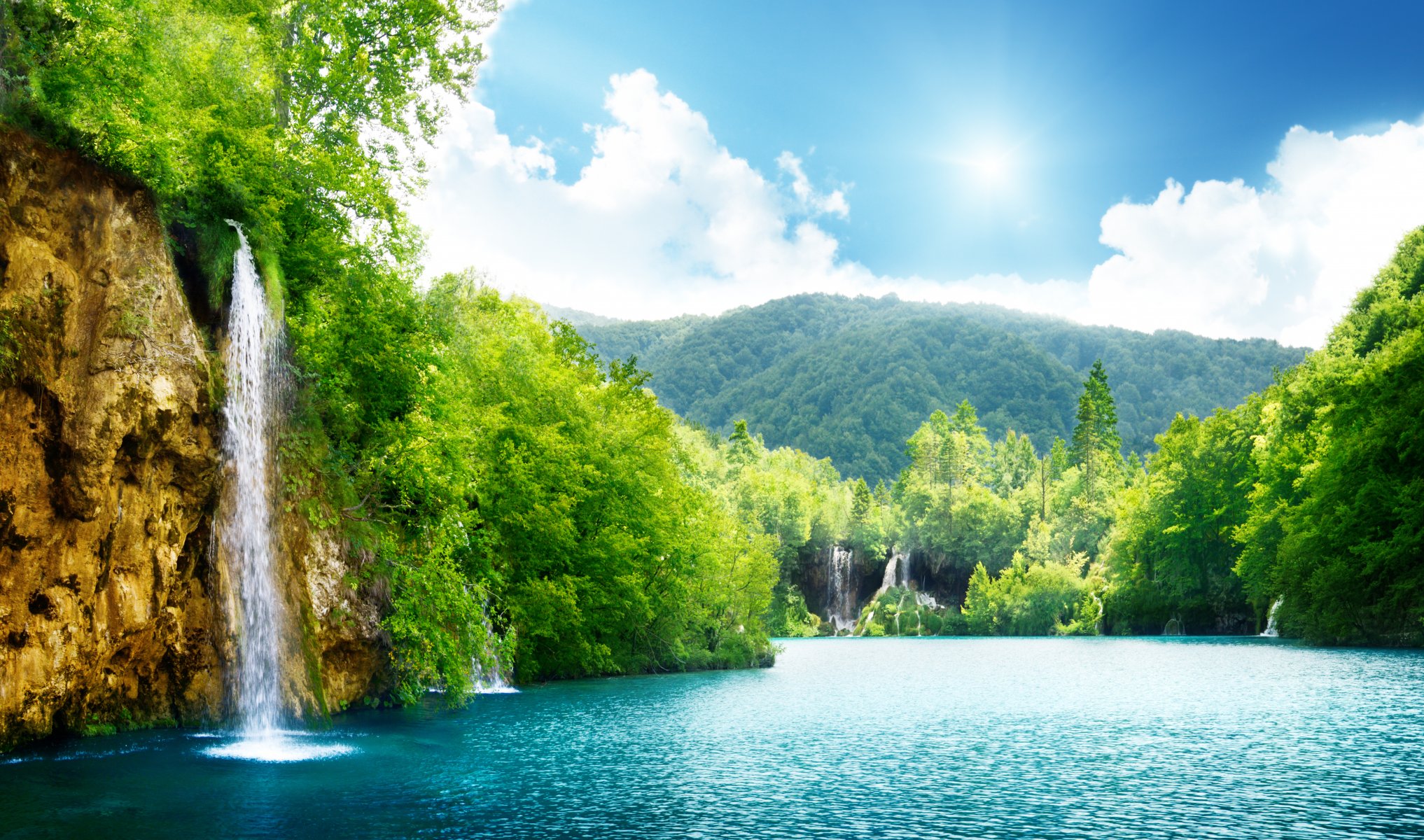 waterfall sea lake deep forest trees sky clouds landscape nature dense forest beautiful sunlight