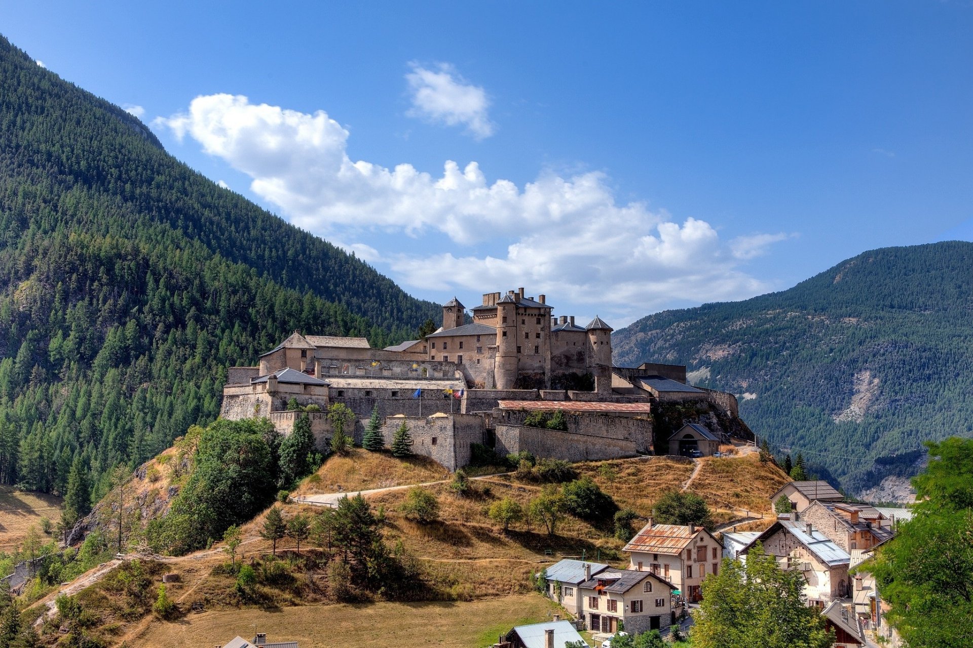 mountains forest sky clouds trees castle houses city town landscape panorama