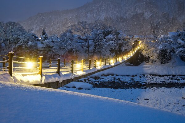 Yellow lanterns on the bridge over the river