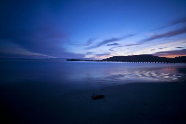 The dying sunset over the sea - view from the pier