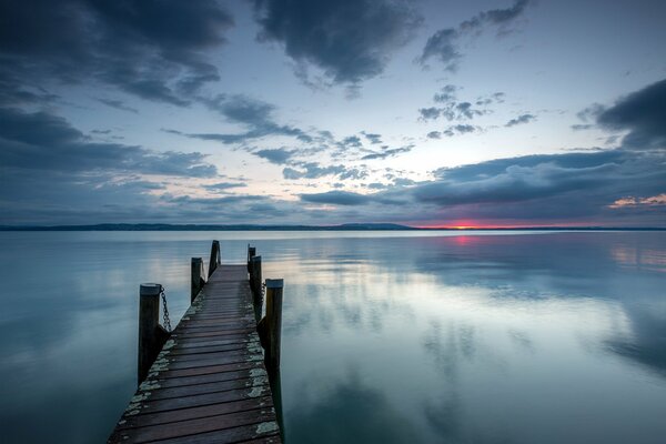 A lonely bridge leading into the depths of the lake