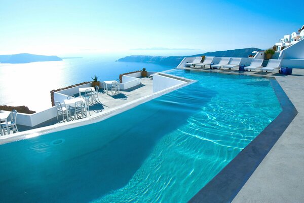 En Santorini habitación de hotel con piscina con vistas al mar