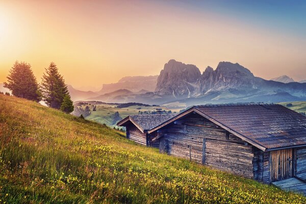 Wooden house at the foot of the mountain plains