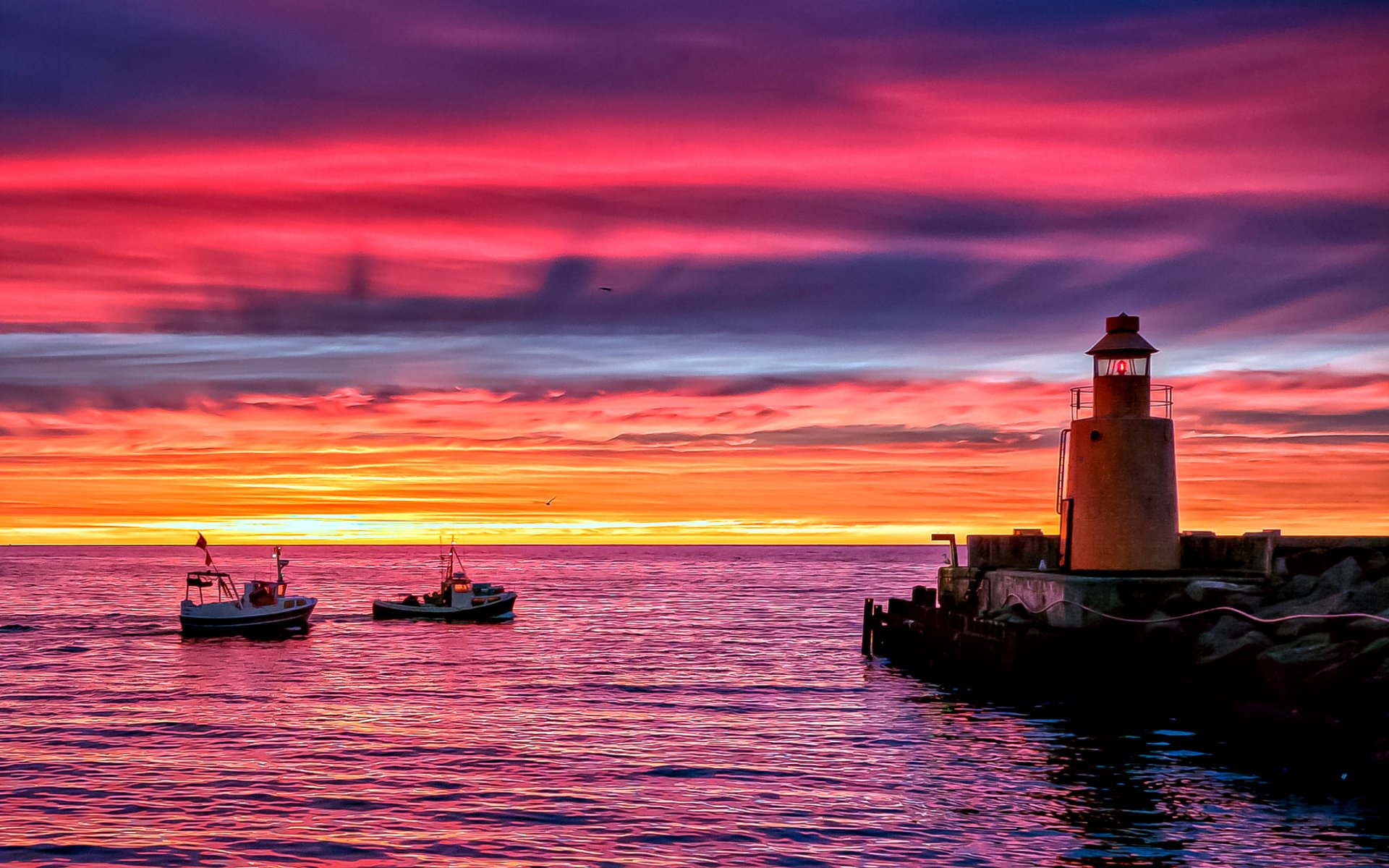 lighthouse pier pier shore sea ocean boats evening twilight sunset