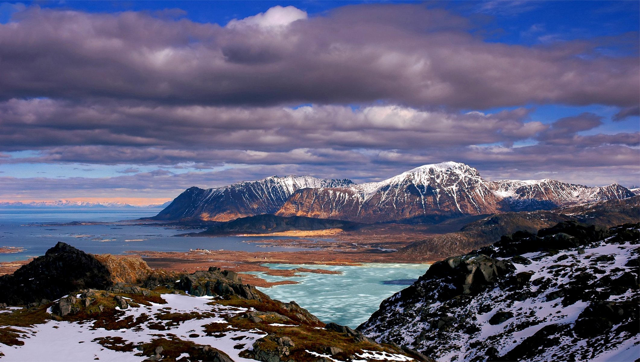 mountains hills rocks moss snow blue blue sky clouds sea nature