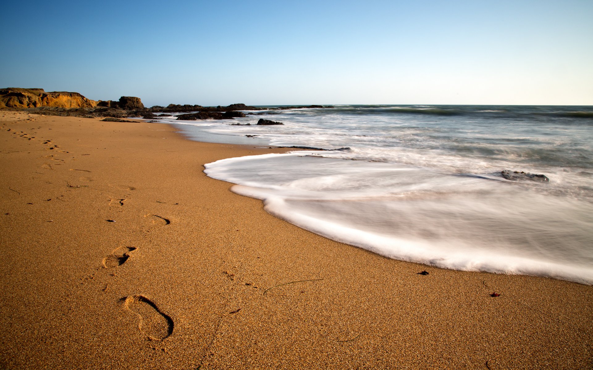 beach coast sand traces sea day blue sky