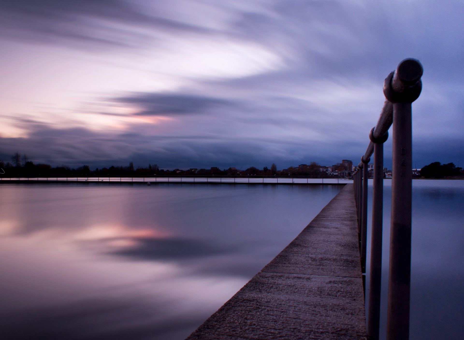 united kingdom england town night sunset sky clouds beach rails lake water surface of reflection