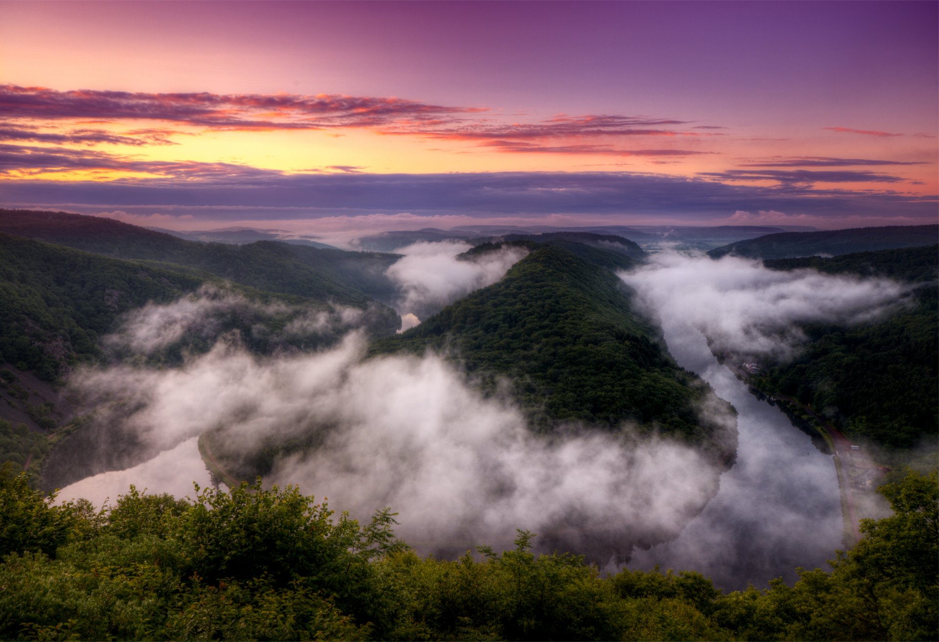 germany river bend saarland saarschleife evening bright orange sunset lilac sky clouds view altitude panorama